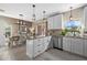 Open kitchen with granite island and stainless steel appliances that adjoins to the dining area at 14932 Amberjack Ter, Lakewood Ranch, FL 34202