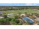 Aerial view features a sports field, playground and green spaces surrounded by trees at 14932 Amberjack Ter, Lakewood Ranch, FL 34202