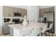 Modern eat-in kitchen featuring stainless steel appliances, sleek cabinets, and island at 15101 Cuzcorro Ct, Nokomis, FL 34275