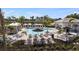 Community pool with lounge chairs, umbrellas, and well-maintained landscaping at 15105 Cuzcorro Ct, Nokomis, FL 34275