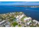 Aerial view of condo buildings in a waterfront location with mature trees and tennis courts at 1600 1St W Ave # 102A, Bradenton, FL 34205