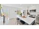 Updated kitchen with stainless steel appliances, white countertops, shaker cabinets, and a center island with bar seating at 1600 1St W Ave # 102A, Bradenton, FL 34205