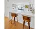 Modern kitchen showcasing an island with seating, quartz counters, and open to living area at 1600 1St W Ave # 102A, Bradenton, FL 34205