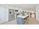 Open kitchen with a large island, seating, stainless steel appliances, and bright, airy design at 1600 1St W Ave # 102A, Bradenton, FL 34205