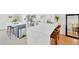 A modern kitchen with white cabinets, stainless steel appliances, and a large island at 1600 1St W Ave # 102A, Bradenton, FL 34205