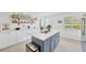 Bright kitchen boasts a center island, stainless appliances, and lots of storage at 1600 1St W Ave # 102A, Bradenton, FL 34205