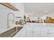 Kitchen featuring a modern sink, white countertops, and open layout to the living room at 1600 1St W Ave # 102A, Bradenton, FL 34205