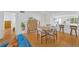 Open concept living area flowing into the kitchen and dining space, with wood floors and plenty of natural light at 1600 1St W Ave # 102A, Bradenton, FL 34205