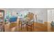 Open floor plan featuring a living area and dining space with wood floors and access to the bathroom at 1600 1St W Ave # 102A, Bradenton, FL 34205