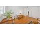 Cozy living room with hardwood floors, a desk, and large windows for natural light at 1600 1St W Ave # 102A, Bradenton, FL 34205