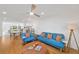 Bright open living room features a ceiling fan and wood floors at 1600 1St W Ave # 102A, Bradenton, FL 34205