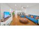 Bright open living room features a ceiling fan and wood floors at 1600 1St W Ave # 102A, Bradenton, FL 34205