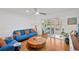 Comfortable living room with wood floors, ceiling fan, and sliding glass doors to outdoor space at 1600 1St W Ave # 102A, Bradenton, FL 34205