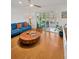 Comfortable living room featuring wood floors, a ceiling fan, and sliding glass doors at 1600 1St W Ave # 102A, Bradenton, FL 34205