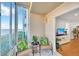 This sunroom features wicker chairs with views of the water and the living room at 1600 1St W Ave # 102A, Bradenton, FL 34205