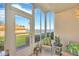 Bright sunroom with wicker chairs, water views, and great natural light at 1600 1St W Ave # 102A, Bradenton, FL 34205