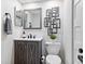 Stylish half-bathroom with modern vanity, decorative mirror, and sleek fixtures creating a chic powder room at 1620 Boathouse Cir # 101, Sarasota, FL 34231