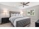 Serene main bedroom featuring a luxurious upholstered bed, ceiling fan, and a bright window at 1620 Boathouse Cir # 101, Sarasota, FL 34231