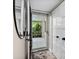 Bright entryway with a mirror, a view to the patio, and a sliding glass door at 1620 Boathouse Cir # 101, Sarasota, FL 34231