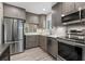 Modern kitchen featuring stainless steel appliances, gray cabinets, and light-colored countertops at 1620 Boathouse Cir # 101, Sarasota, FL 34231
