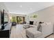 Bright, spacious living room featuring a comfortable sectional sofa, TV, and access to the outdoor patio at 1620 Boathouse Cir # 101, Sarasota, FL 34231