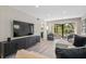 Airy living room with a large TV, comfortable seating, and an open layout with views to the outside at 1620 Boathouse Cir # 101, Sarasota, FL 34231