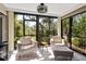 Bright sunroom with ample natural light, comfortable seating, and views of the surrounding greenery at 1620 Boathouse Cir # 101, Sarasota, FL 34231