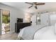 Bright main bedroom with an upholstered bed, ceiling fan, access to an outdoor area, and barn door feature at 1620 Boathouse Cir # 101, Sarasota, FL 34231