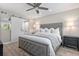 Inviting main bedroom features a comfy upholstered bed, ceiling fan, and a sliding barn door feature at 1620 Boathouse Cir # 101, Sarasota, FL 34231