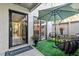 Charming patio area with a table, chairs, an umbrella, and a view through a glass door at 1620 Boathouse Cir # 101, Sarasota, FL 34231