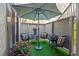 A cozy outdoor patio space features stylish seating, a small table, and an umbrella for shade at 1620 Boathouse Cir # 101, Sarasota, FL 34231