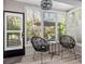 Cozy sun room with shuttered windows, offering bright light and views of the surrounding tropical foliage at 1620 Boathouse Cir # 101, Sarasota, FL 34231