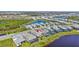 This drone photograph exhibits the property's place next to a pond and other dwellings at 16816 Seraphic Trl, Lakewood Ranch, FL 34211