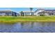 Landscaped backyard featuring a serene pond view and lush greenery at 16816 Seraphic Trl, Lakewood Ranch, FL 34211