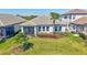 Backyard of the house with a covered patio, a grassy lawn, and beautiful plants at 16816 Seraphic Trl, Lakewood Ranch, FL 34211