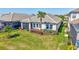 Backyard of the house with a covered patio, a grassy lawn, and beautiful plants at 16816 Seraphic Trl, Lakewood Ranch, FL 34211