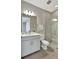 Bathroom featuring single vanity, large mirror, and stand up shower with glass door at 16816 Seraphic Trl, Lakewood Ranch, FL 34211