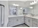 Elegant bathroom featuring double vanity with quartz countertop, gray cabinets, and designer fixtures at 16816 Seraphic Trl, Lakewood Ranch, FL 34211