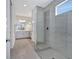 Modern bathroom featuring a glass-enclosed shower with gray tiling, vanity, and ample natural light at 16816 Seraphic Trl, Lakewood Ranch, FL 34211