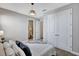 Bedroom with a queen bed, two side tables, and closets at 16816 Seraphic Trl, Lakewood Ranch, FL 34211