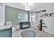 Neutral Bedroom with crib, chair, and unique tree-shaped shelving at 16816 Seraphic Trl, Lakewood Ranch, FL 34211