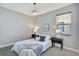 Bedroom with a queen bed, two side tables, and grey carpet at 16816 Seraphic Trl, Lakewood Ranch, FL 34211