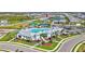 Aerial view of the luxurious community pool, clubhouse, tennis courts, and playground with surrounding homes at 16816 Seraphic Trl, Lakewood Ranch, FL 34211