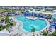 A sprawling community pool with lounge chairs, umbrellas, and ample space for swimming and socializing at 16816 Seraphic Trl, Lakewood Ranch, FL 34211