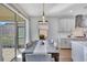Dining area near a bright kitchen with stainless steel appliances and bar seating, and an open flow at 16816 Seraphic Trl, Lakewood Ranch, FL 34211
