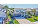 Beautiful single Gathering home with a two-car garage, paver driveway, and lush landscaping at 16816 Seraphic Trl, Lakewood Ranch, FL 34211