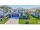 Beautiful single Gathering home with a two-car garage, paver driveway, and lush landscaping at 16816 Seraphic Trl, Lakewood Ranch, FL 34211