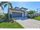 Attractive home features a well-kept lawn, a paver driveway, and lush landscaping at 16816 Seraphic Trl, Lakewood Ranch, FL 34211