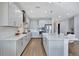 Beautiful kitchen with stainless steel appliances, white cabinets and quartz countertops, and a large island with bar seating at 16816 Seraphic Trl, Lakewood Ranch, FL 34211