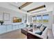 Bright and airy living room with tray ceilings, wood beams, stylish furnishings, and lots of natural light at 16816 Seraphic Trl, Lakewood Ranch, FL 34211